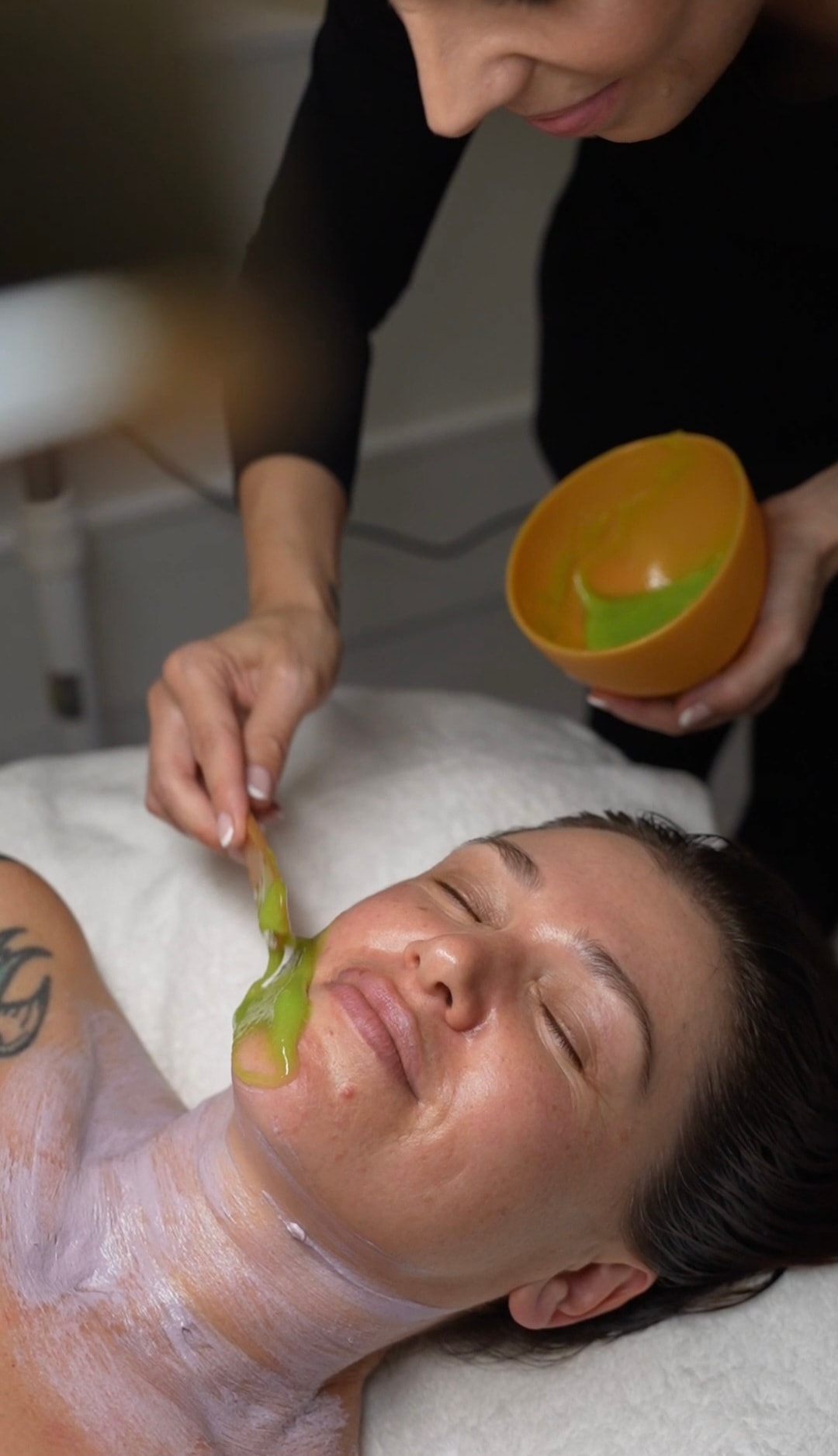 Green facial mask application at Bayshore Beauty
