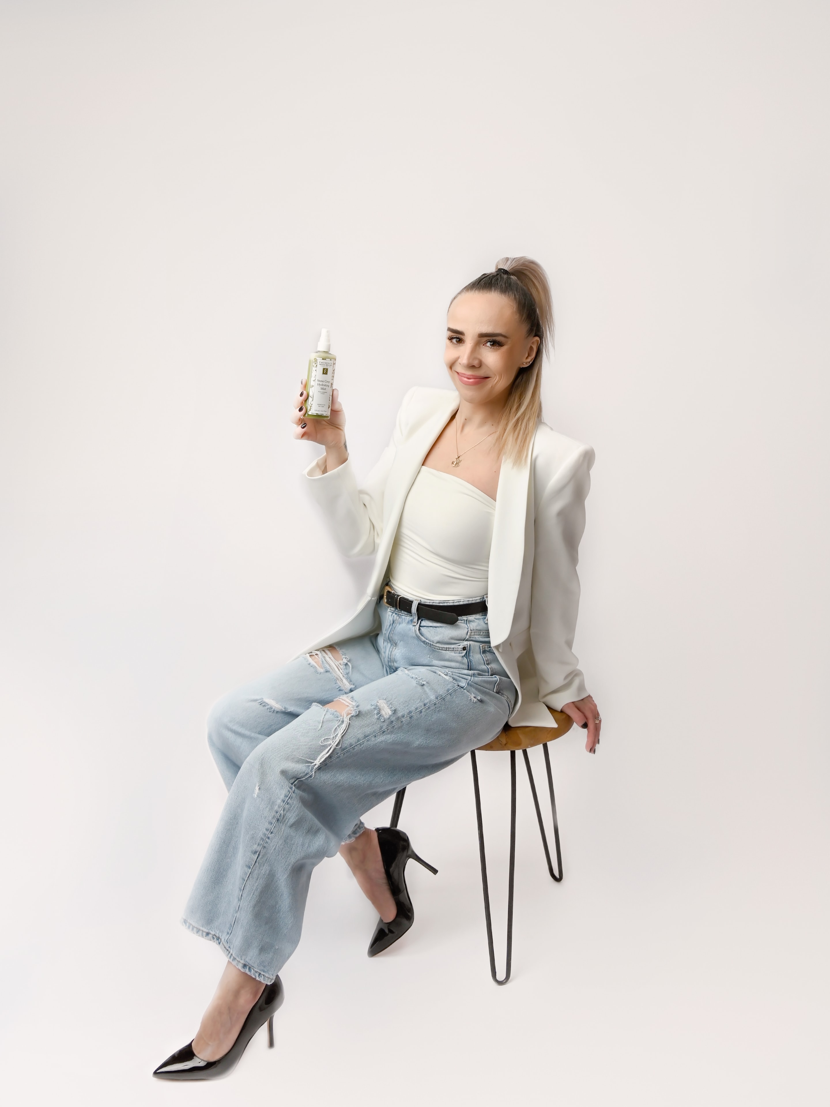 Victoria holding an Eminence skincare product at Bayshore Beauty